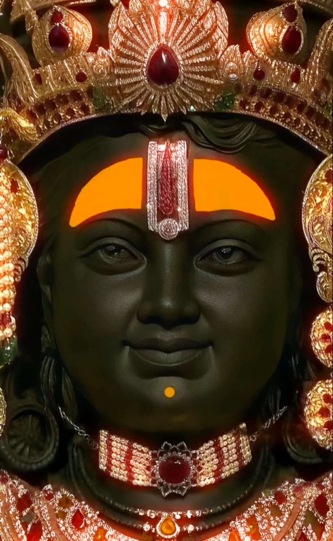 Close-up decorated face of Lord Vitthal with crown, ornaments, and tilak.