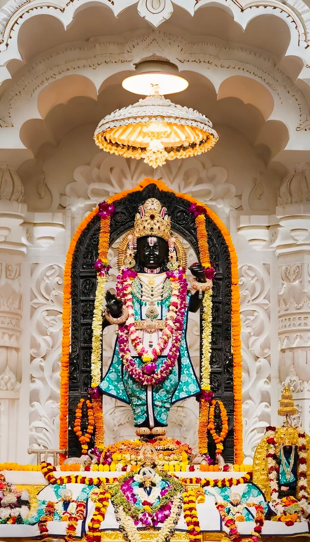 Lord Vitthal idol decorated with flowers and ornaments in temple shrine.